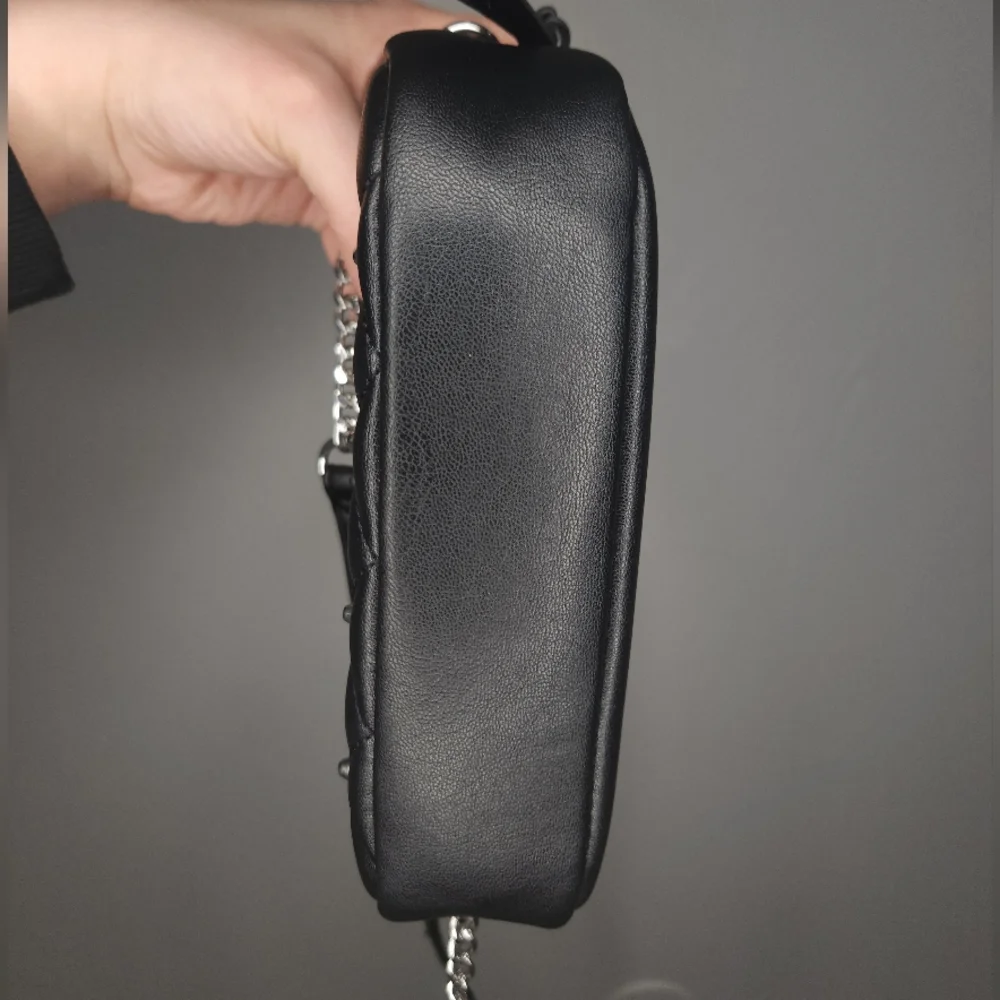 Rebecca Minkoff• Mini quilted studded black crossbody bag. 7.25” x 2.25” x 5.25”